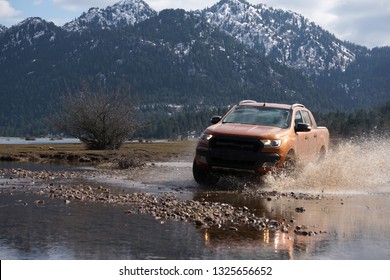   Pick Up Truck Is Off Roading In The Mud                             