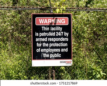 Pickering Canada, June 7, 2020; Armed Response Warning Sign At The Ontario Power Generation Pickering Nuclear Power Plant On The Shore Of Lake Ontario