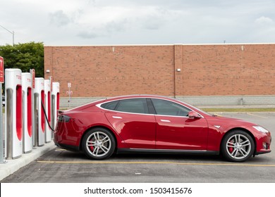 PICKERING, CANADA - September 6, 2019: Side of Tesla Model S while plugged-in and charging at Supercharger. 