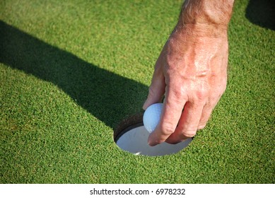 picking up ball out of cup