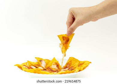 Picking Tortilla Chips Covered With Cheese (Nachos) From White Dish On Isolated White Background