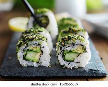 picking up vegetarian sushi with chopsticks - Powered by Shutterstock