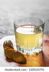 Pickle Juice Glass On Wooden Plate 