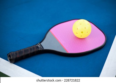 Pickleball Paddle And Ball On The Court. 