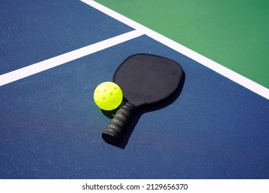 Pickleball Paddle And Pickle Ball Of Court.                         