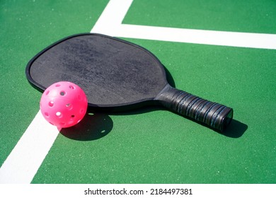 Pickleball Paddle And Pickle Ball On Court.                            