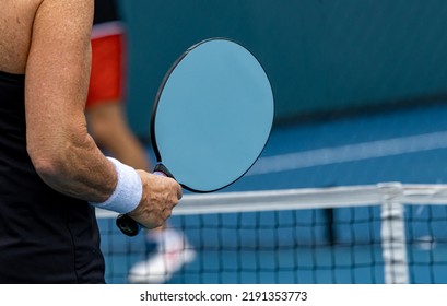 Pickleball paddles can be oval or rectangular. - Shutterstock ID 2191353773