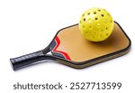 Pickleball is a racket or paddle sport in which two or four players use a smooth faced paddle to hit a perforated, hollow plastic wiffle ball. Isolated on white background with copy space