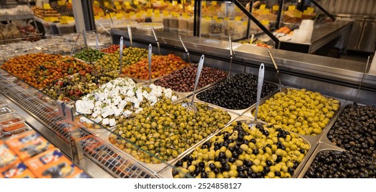 Pickled black and green olives, marinated in olive oil or feta cheese, with spices and onions. Mediterranean healthy food. Haagse Market in The Hague, Netherlands. - Powered by Shutterstock