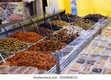 Pickled black and green olives, marinated in olive oil or feta cheese, with spices and onions. Mediterranean healthy food. Haagse Market in The Hague, Netherlands. - Powered by Shutterstock