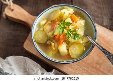 Pickled Cucumber Soup With Vegetables On A Wooden Background