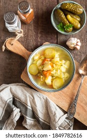 Pickled Cucumber Soup With Vegetables On A Wooden Background