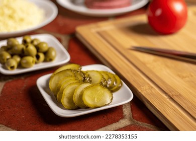Pickled cucumbers and olives. Ingredients for pizza. - Shutterstock ID 2278353155