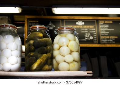 Pickled Eggs, Cucumbers and Onions on a British Fish and Chip shop counter 