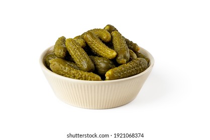 Pickled Gherkins In A Beige Ceramic Bowl Isolated On A White Background. Whole Green Cornichons Marinated With Dill, Garlic And Mustard Seeds. Crunchy Baby Pickles. Tasty Canned Vegetables. Front View