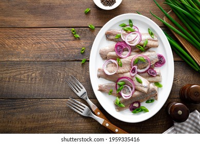 Pickled Herring Fillet With Onion On Plate
