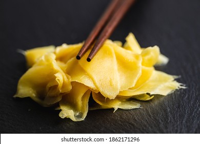 Pickled sushi ginger slices on black stone cutting board. - Powered by Shutterstock