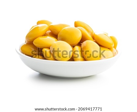 Pickled yellow Lupin Beans in bowl isolated on white background.