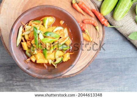pickles consist of cucumber, pineapple, carrot and chili usually as an addition to the kebuli rice flavoring