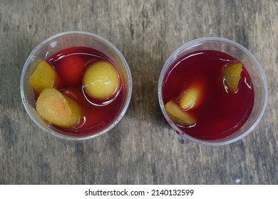 Pickles And Pickle Juice In Plastic Glass