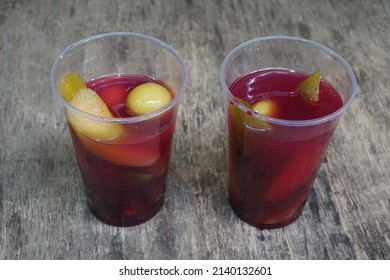 Pickles And Pickle Juice In Plastic Glass