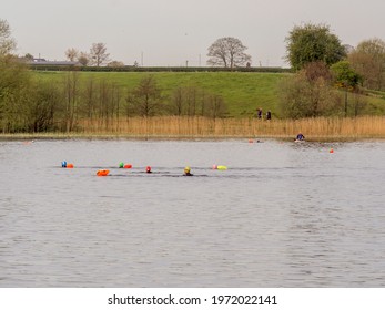 Pickmere Lake, Pickmere, Knutsford, Cheshire, UK. 24th April 2021. Open Water Swimmer Group Taking Part In Organised Open Water Swimming Training, Pickmere, Knutsford, Cheshire, Uk