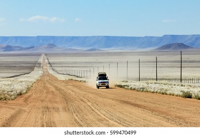 Pickup Truck Driving Fast On Long Straight Desert Road