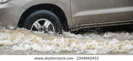 Pickup truck was driving through flooded roads where floods are caused by heavy rains and cause vehicle undercarriage and engine damage, concept for car insurance.