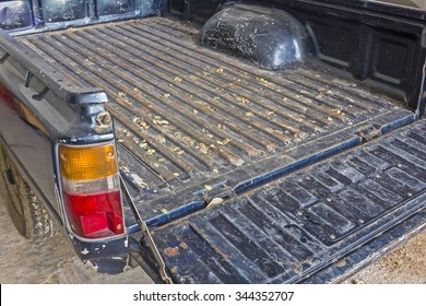 Pickup Truck Indicartor - The Tailgate Of A Blue Battered Eighties Pickup Truck In Rear.