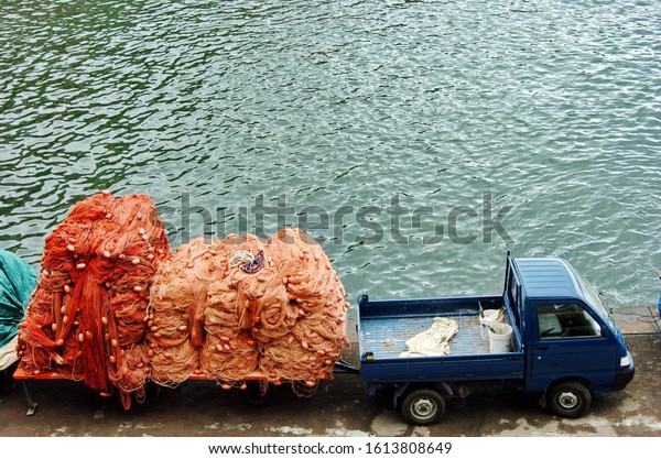 Pickup\
truck nets and sea in the fishing port in\
Sorrento