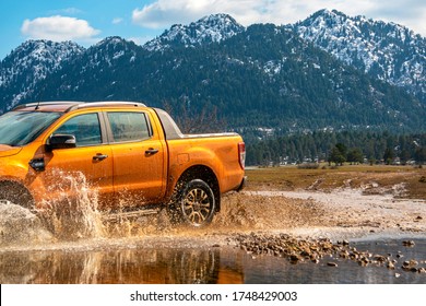 pick-up truck is off roading in the mud of the river in the mountains of Antalya