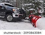 Pickup truck with snowplow in winter after snowstorm 