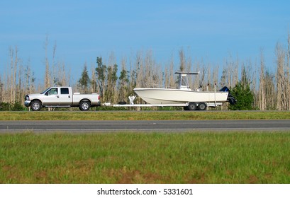 Pickup truck towing boat on trailer