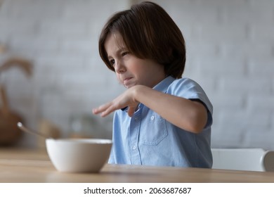 Picky Angry Eater Kid Disappointed And Disgusted With Meal For Breakfast, Hates Healthy Food, Has No Appetite. Emotional Boy Refusing Lunch, Turning Away From Bowl. Children Eating Behavior Disorder