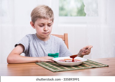 Picky Eater Child Eating Soup With Disgust