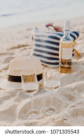 Picnic Background With Bag, Grape And White Wine On The Beach By Blue Sea