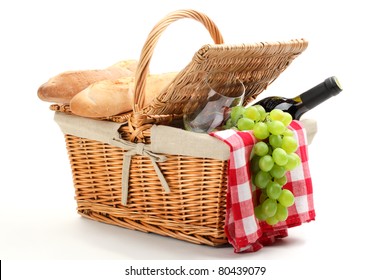 Picnic basket filled with fruit,bread and red wine.