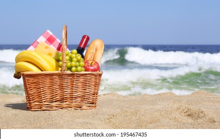 Picnic basket with food on the beach 