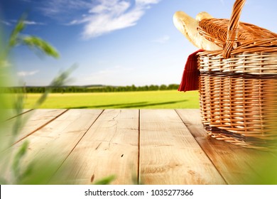 Picnic basket on table and spring landscape.  - Powered by Shutterstock