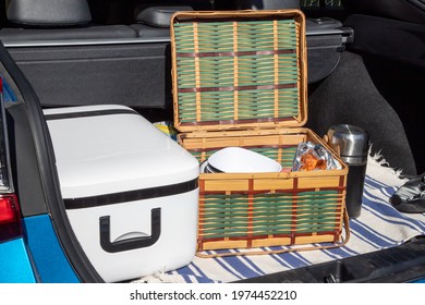 Picnic Basket With Snacks And A Cooler In The Trunk Boot Of A Car