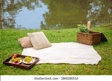 Picnic blanket with basket and pillows