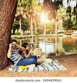 Picnic, kids or camera in nature with picture photography or magnifying glass for fun games, travel or playing. Friends, photo and children in forest for holiday adventure or wilderness environment - Powered by Shutterstock