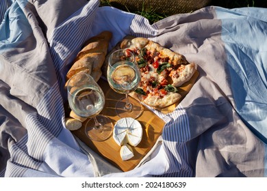 Picnic In Nature: Pizza, Cheese, Baguette And Glasses Of Wine.