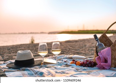 Picnic on the beach, romantic atmosphere. Sunset and dinner. Relax on the beach. Copy spac - Powered by Shutterstock