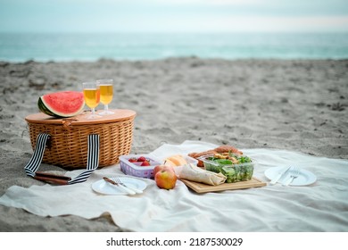Picnic is set up on the beach. Wicker basket with food and drink for romantic picnic and relaxing. chill and good vibe. - Powered by Shutterstock