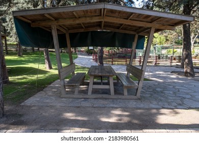 Picnic Shelter Or Covered Picnic Table In Public Park.  Wooden Eating Bench.