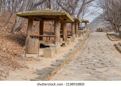 Picnic shelters on side of cobblestone walking path in mountain wilderness park. - Powered by Shutterstock