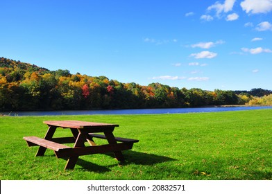 Picnic table in beautiful park during autumn