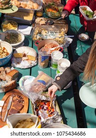 A Picnic Table Full Of Food At An Outdoor Picnic Potluck Community Lunch.