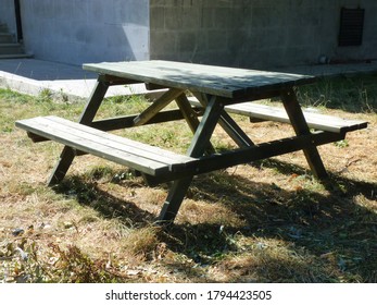 Picnic Table Made Of Weathered Wood As A Symbol Of Summer And Barbecue Leisure Activity.